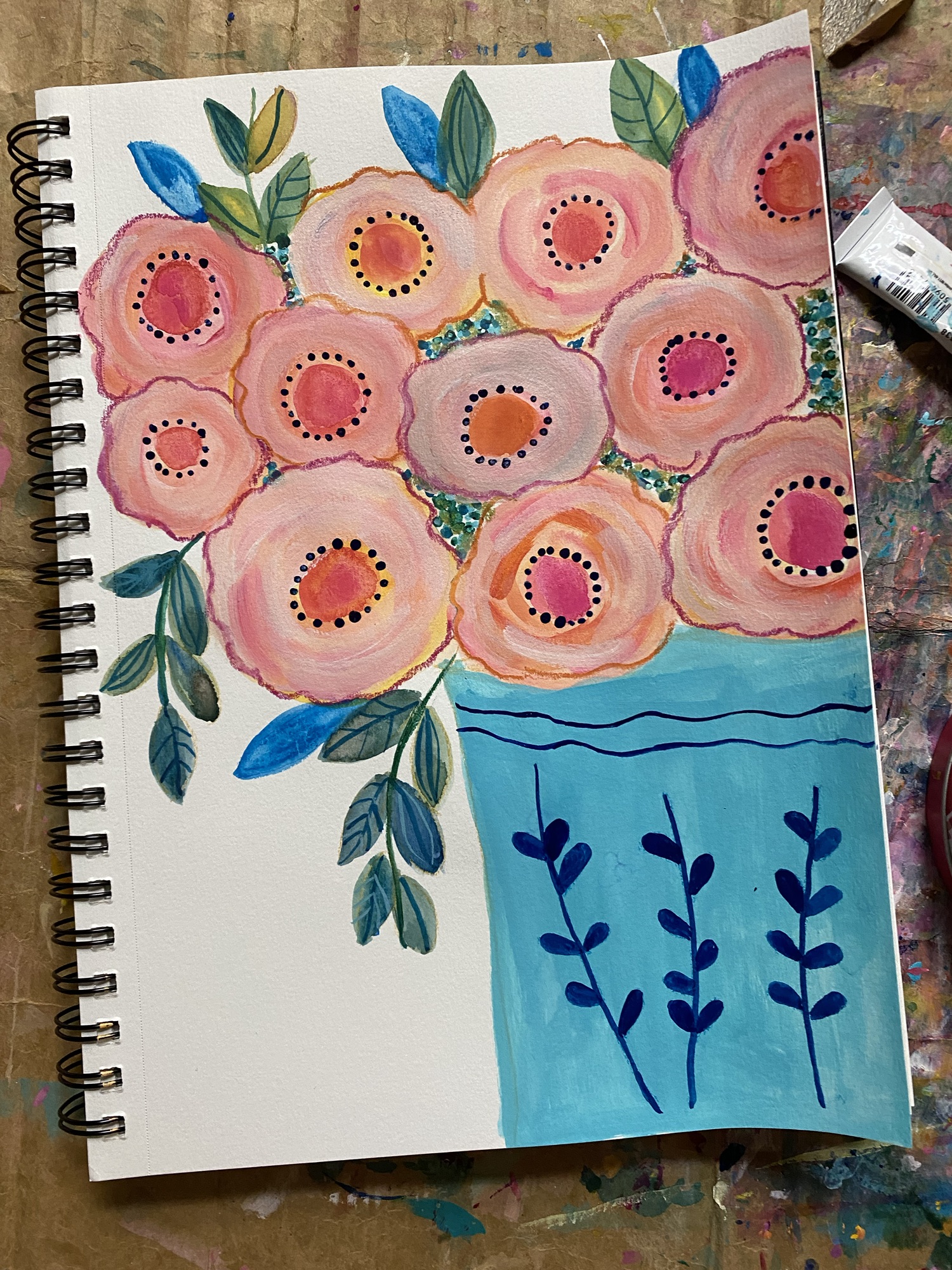 11 pink flowers in a blue leave vase